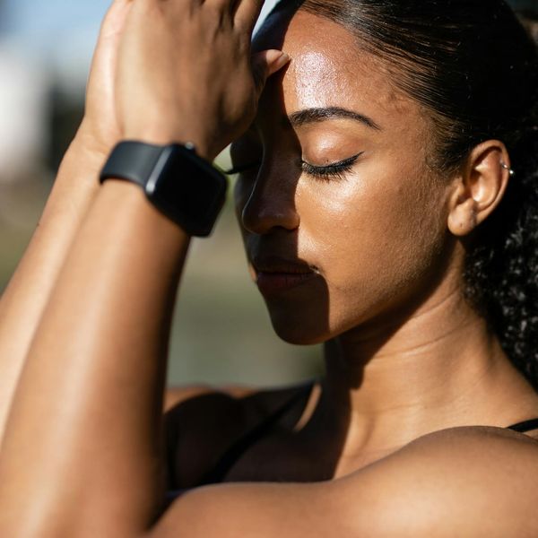 Person meditating peacefully outdoors with soft sunlight.